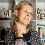 Béa, fondatrice de Femmes en Harmonie, grimace en raison de douleurs aux épaules et au cou,